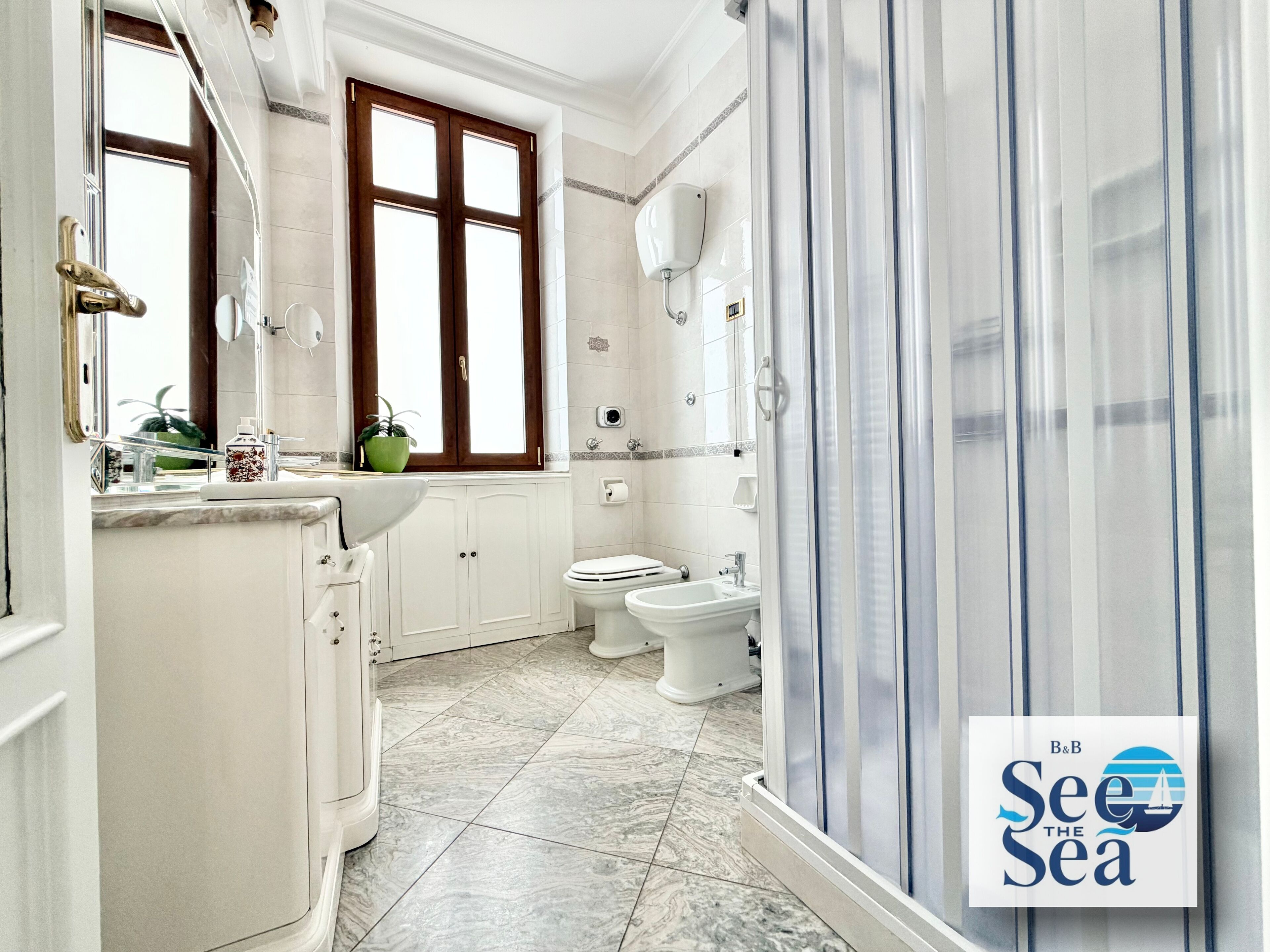 A bathroom with a sink, toilet, and shower area.