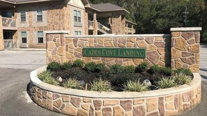 A stone building with a sign reading "Cades Cove Landing." - Riverside Retreat at Cades Cove Landing-Unit 250 in Enchanting Townsend, TN (Townsend)