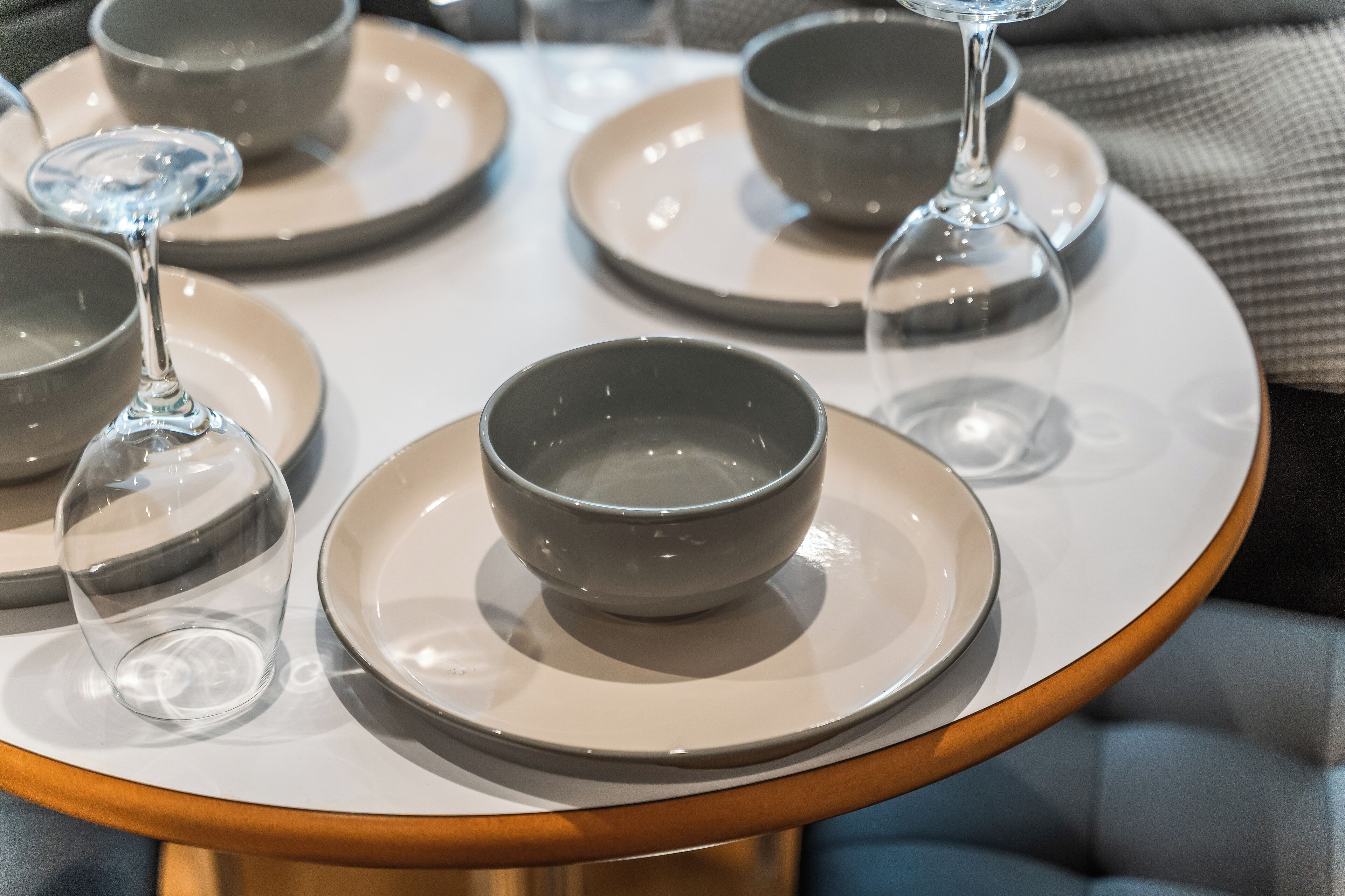 A table with several bowls and wine glasses.