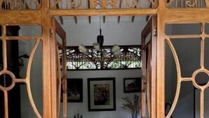 A wooden dining area with a patterned floor, a chandelier, and framed artwork on the walls. - Room for couples in Palermo - Antioquia (Támesis)