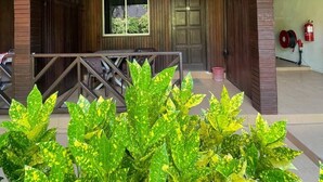 A covered outdoor area with a wooden railing, a large window, and a door. - The Reef Bluestar Perhentian (Pulau Perhentian Besar)