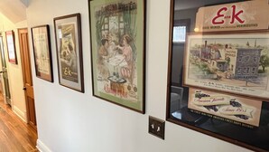 A hallway with framed vintage wine advertisements on the wall. - Private 1-bdrm unit, newly renovated historic home, downtown Sandusky. (Sandusky)