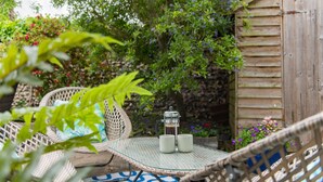 A wicker chair with a glass table, two mugs, and a French press. - Michaelmas Cottage, Broadstairs (Broadstairs)