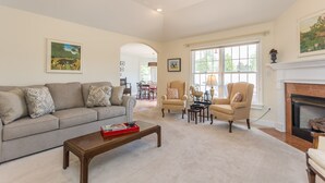 A spacious living room with a sofa, armchairs, a fireplace, and artwork on the walls. - Private & Spacious - Near JMU & Massanutten - Grill + Firepit - Sleeps 10 (Penn Laird)