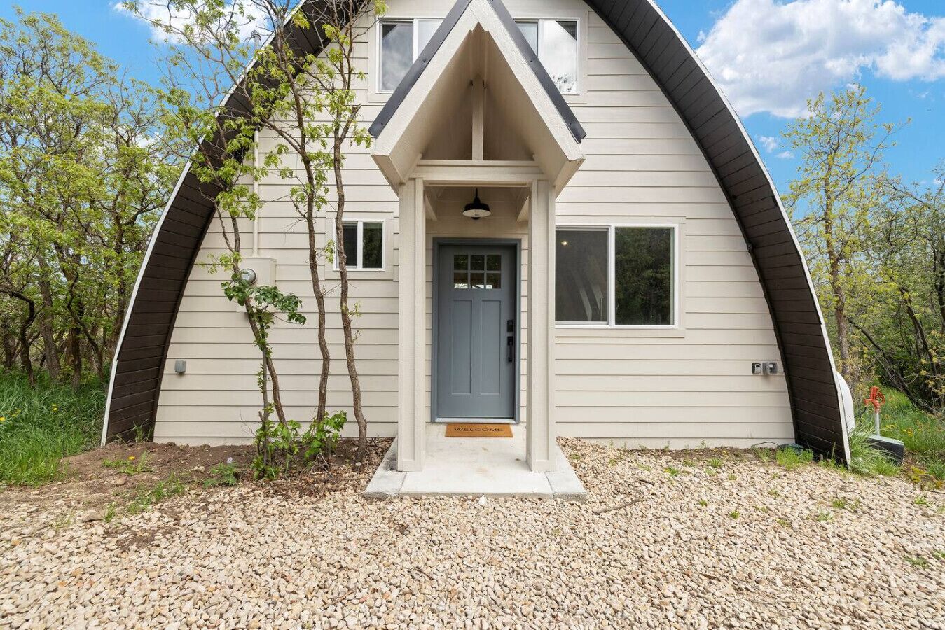 A house with a unique curved roof and a welcoming entrance.