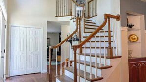 A staircase with wooden railings and white balusters, leading to an upper floor. - Must see 4/3 Family/Pet Friendly+Pool&hot tub (Galax)