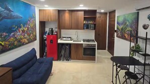 A compact living space with a kitchenette, a dining area, and a sofa. - New studio Apt. in the coveted Zona Romantica with roof top pool (Puerto Vallarta)