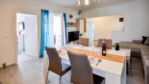 A modern living room with a dining area, a TV, and a staircase. - Amazing apartment in Novigrad with swimming pool (Novigrad)