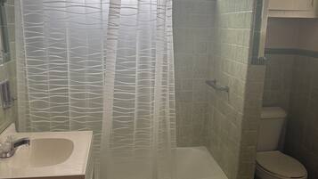 Shower, hair dryer, towels, toilet paper