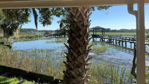 A covered area with a view of a water body and a dock. - Dock&Volleyball! Near Downtown - Flamingo Flat (Savannah)