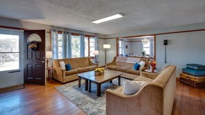 A spacious living room with two sofas, a coffee table, and a dining area. - Dock&Volleyball! Near Downtown - Totally Turquoise (Savannah)