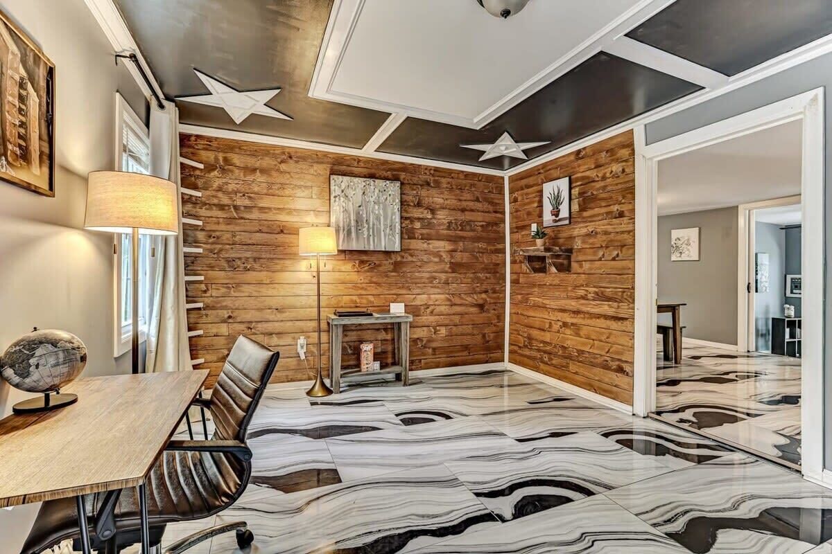 A modern meeting room with a wooden accent wall, a star ceiling design, and a marble floor.