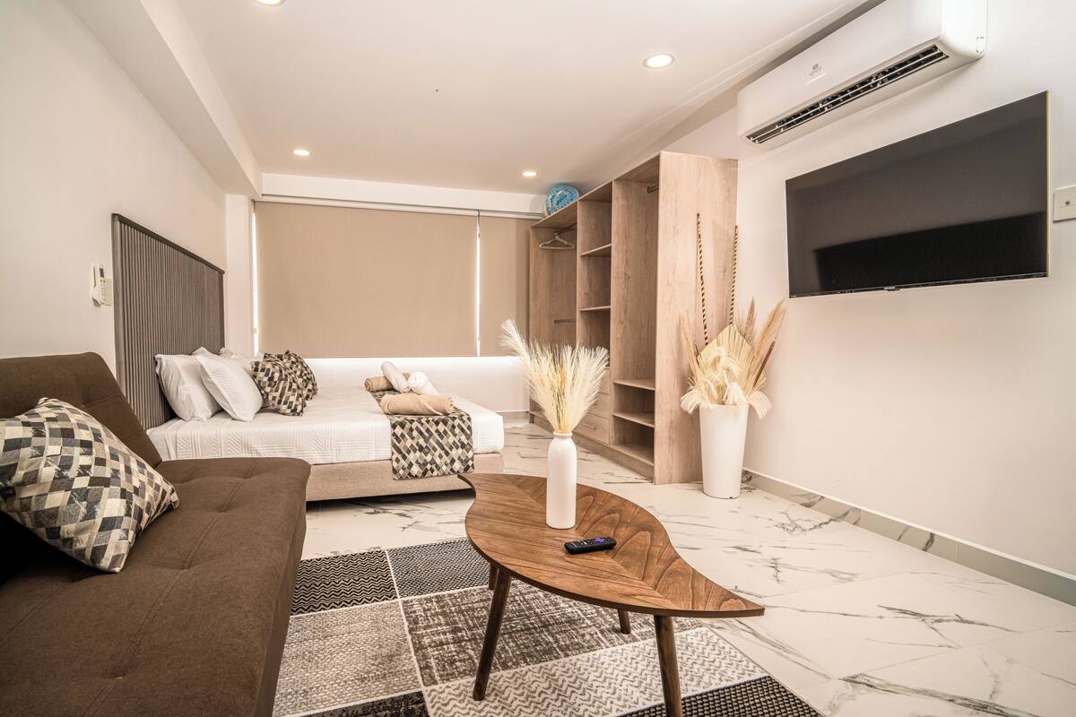 A modern living room with a sofa, coffee table, and TV.