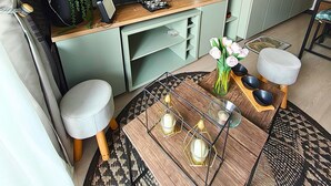 A compact living space with a TV, dining table, and kitchen area. - Vicuña Urban Stay (Santiago)