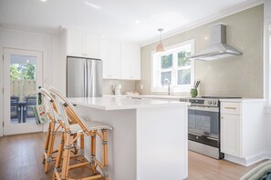 Fridge, stovetop, dishwasher, coffee/tea maker