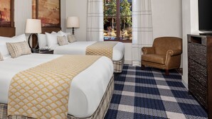 A hotel room with two beds, a TV, a chair, and a view of trees through the window. - 2 bed, 2 bath luxury condo at Marriott's Grand Residence in South Lake Tahoe. (South Lake Tahoe)