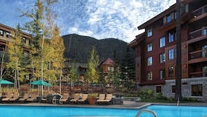 A swimming pool with lounge chairs and a hot tub, surrounded by buildings and trees. - 2 bed, 2 bath luxury condo at Marriott's Grand Residence in South Lake Tahoe. (South Lake Tahoe)