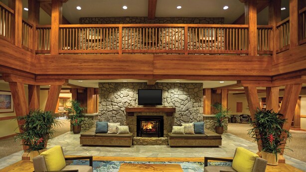 A spacious lobby with a stone fireplace, wooden furniture, and a balcony. - 2 bed, 2 bath luxury condo at Marriott's Grand Residence in South Lake Tahoe. (South Lake Tahoe)