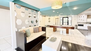 A modern hotel lobby with a pool table, seating area, and a kitchen visible through an open door. - Charming 3BR with WiFi, AC and Parking in Marvelous Los Angeles (Los Angeles)