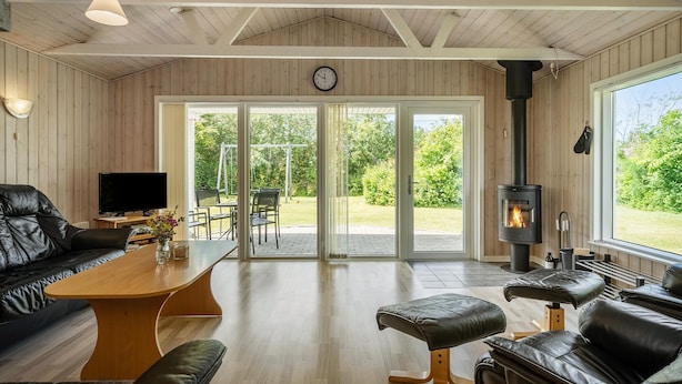 A cozy living room with a sofa, a wooden coffee table, and a fireplace. - Pet friendly home in Tarm with WiFi (Tarm)