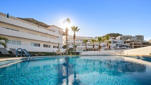 A clear blue pool with steps leading into it, surrounded by white buildings and palm trees. - Pedregal, 2 Pools, Quite, Ocean View, Walk to town (Cabo San Lucas)