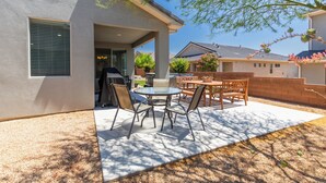A patio with a table and chairs, a grill, and a covered area. - Above Parr - Pet Friendly New Listing (Washington)