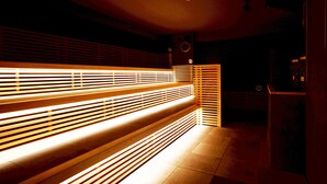 A dimly lit room with a long bench and a small table.