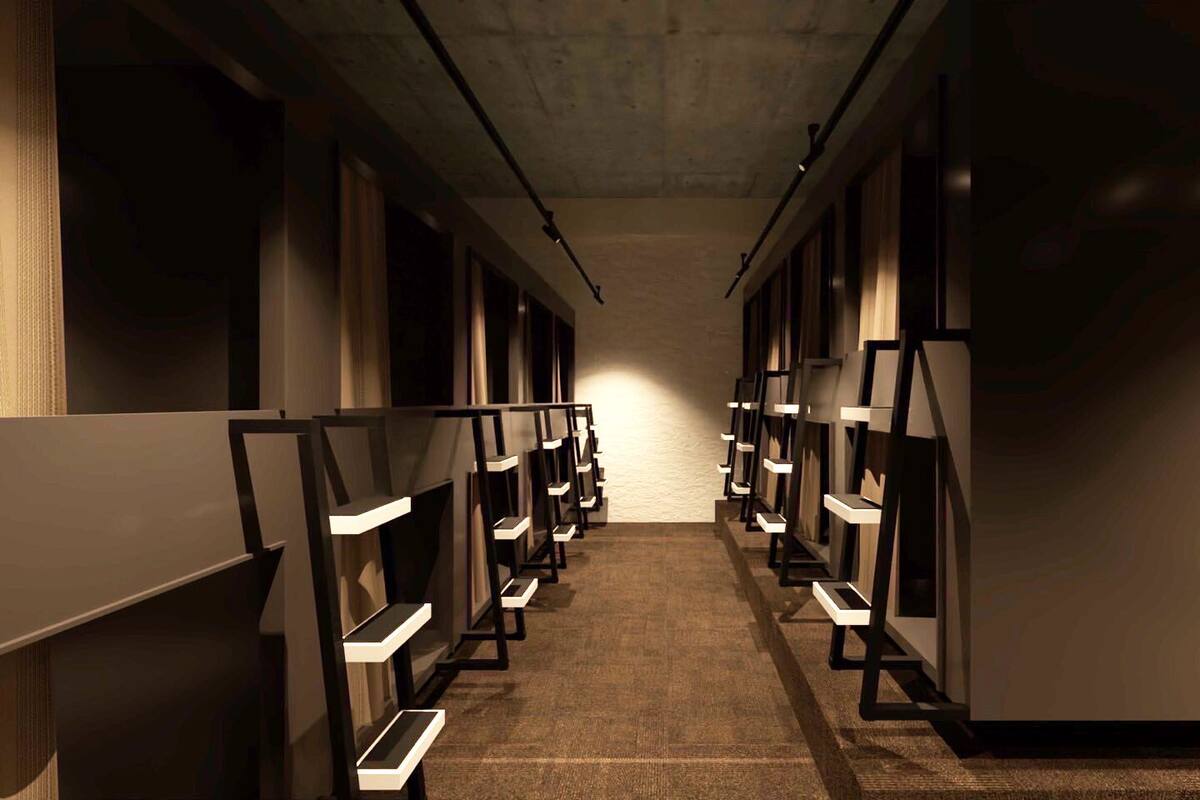 A hallway with multiple rooms, each with a bed and a bedside table.