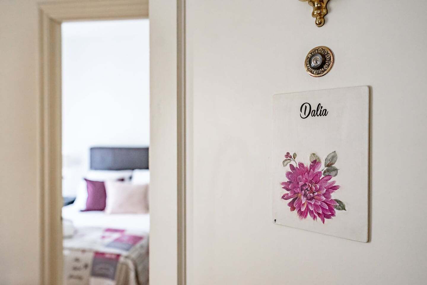 A door with a sign reading 'Dalia' and a floral decoration.