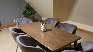 A dining area with a rectangular table and six chairs.