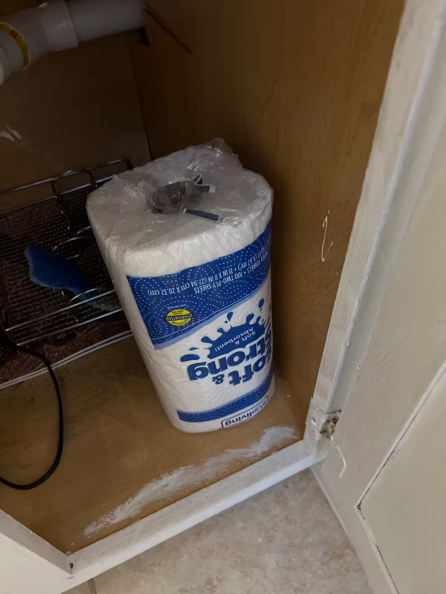 A package of toilet paper in a corner of a room.