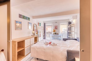 A bedroom with a bed, a wooden dresser, a desk, and a chair. - Old Castle Apartment, Menton, France (Menton)
