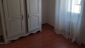 A room with two white wardrobes, a wooden floor, and sheer white curtains. - CORBIERES HOUSE NEAR LAGRASSE (Saint-Pierre-des-Champs)