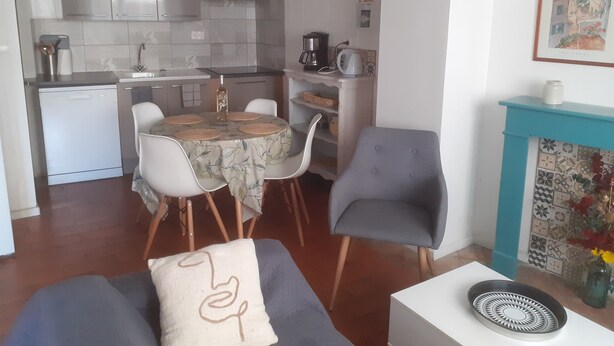 A compact living space with a kitchen, dining area, and a fireplace. - CORBIERES HOUSE NEAR LAGRASSE (Saint-Pierre-des-Champs)