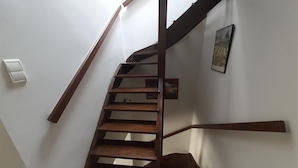 A wooden staircase with a handrail, a light switch, and a framed picture on the wall. - CORBIERES HOUSE NEAR LAGRASSE (Saint-Pierre-des-Champs)