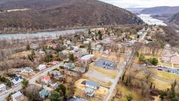 A residential area with houses, a large building, and a river.