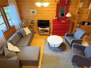 A cozy living room with a sofa, armchair, and a coffee table.