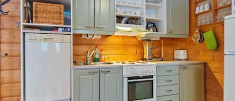 A kitchen with a dishwasher, stove, oven, and various kitchen utensils.