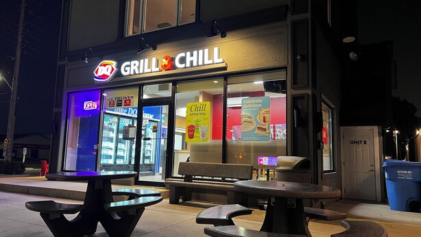 A restaurant named Grill & Chill with outdoor seating and a neon sign. - Three Bedroom Bungalow with free parking, closer to commercial area and highway (Mississauga)