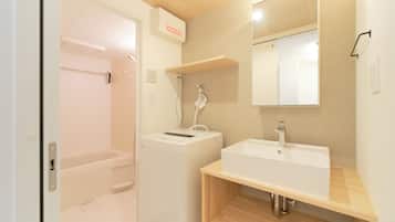 Combined shower/bathtub, hair dryer, slippers, towels