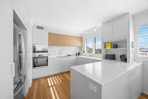 Fridge, microwave, oven, stovetop - Stylish 4-Bed Townhouse with Panoramic Ocean Views (Manly)