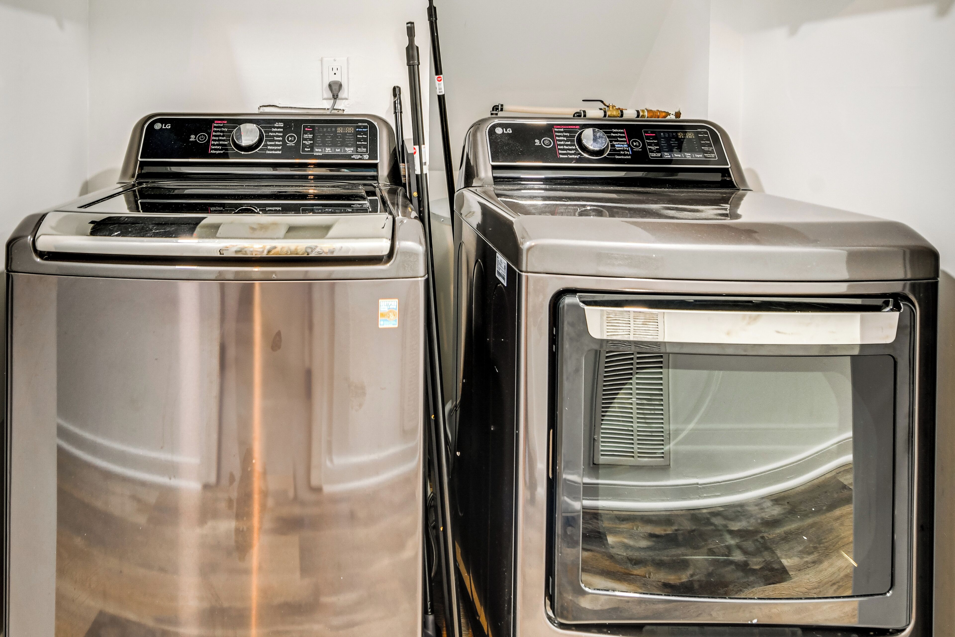 Two stacked laundry machines in a room.