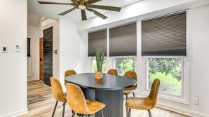 A modern dining area with a round table, six chairs, and a ceiling fan. - Game Room + Yard: Updated House in Chester! (Chester)