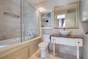 Deluxe One-bedroom Apartment | Bathroom | Bathtub, hair dryer, bidet, soap