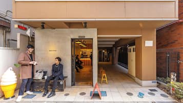 A building entrance with a sign reading 'EIGHT COFFEE' and a bench outside.