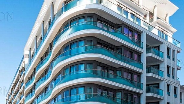 A multi-story hotel with curved balconies and large windows. - 7 Croisette - Apartment 601 (Cannes)