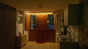 A compact kitchen with wooden cabinets, a built-in sink, and a small countertop. - Love Nest Siena: Romantic Suite with SPA & Jacuzzi (Toscana)