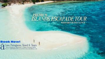 A tropical beach with clear turquoise waters and a white sandy shore.