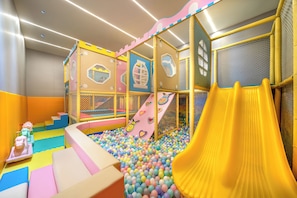 A children's play area with a ball pit, slides, and climbing structures. - Mai Xinge International Hotel  (Shanghai)