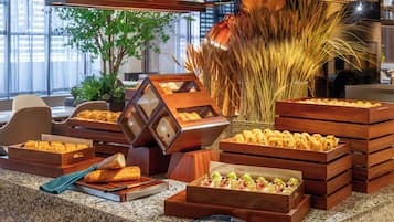 A buffet setup with various food items and a decorative centerpiece.